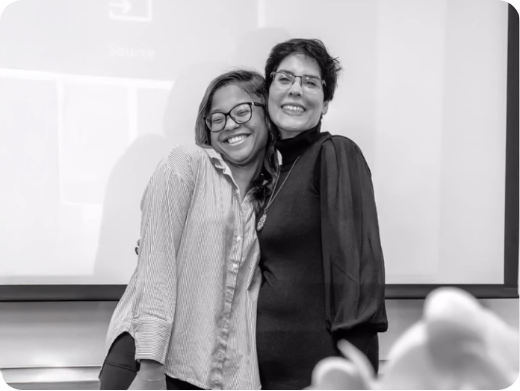 Kellina Powell hugging a woman at a speaking event